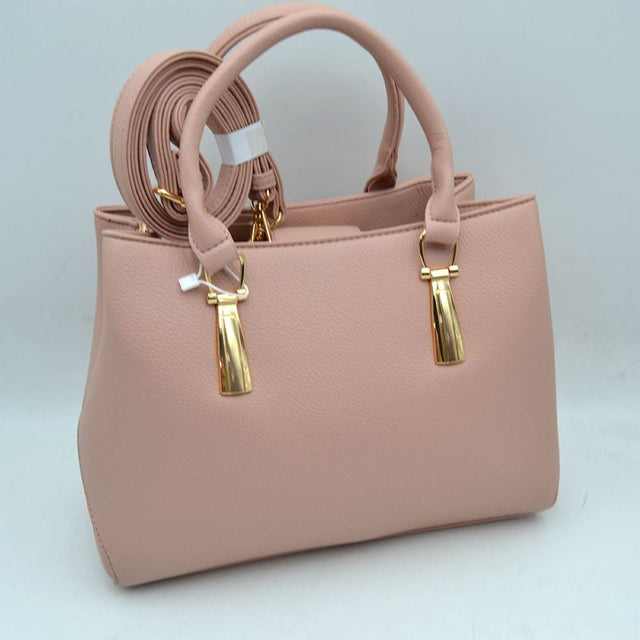 Blush This structured satchel features a clean silhouette and a finely textured exterior finish, making it a sophisticated choice for elevated everyday use. The front panel is detailed with unique, polished metallic vertical hardware attachments that secure the sturdy, rounded dual top handles for a classic hand carry. An open-top style provides convenient access to the main storage compartments
