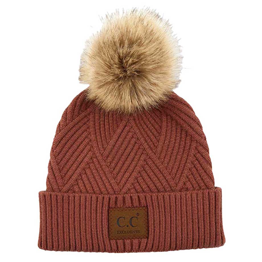 Brick C.C Heather Beanie Hat With Pom Pom And Suede Patch, provides excellent protection and a fashionable look with its soft heather knit material, faux fur pom pom, and stylish suede patch. The fabric is designed to keep you comfortably warm in cold weather. Add this fashionable accessory to the winter wardrobe collection.