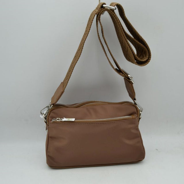 Brown This functional crossbody bag features a smooth, durable nylon exterior in a warm brown tone, making it a practical and versatile choice for organized daily use. Designed with multiple zippered compartments, it includes a convenient front horizontal zipper pocket for quick access to smaller essentials alongside secure main top-zippered sections. The bag is finished with silver-tone hardware and a wide, adjustable shoulder strap featuring a textured pattern for a stylish and comfortable