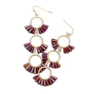 Burgundy Beaded Triple Hoop Dropdown Dangle Earrings, are an eye-catching accessory. With three interlocking rings, each beaded with vibrant colors, this earring set provides a perfect accent to any outfit. Lightweight and fashionable, these earrings can be dressed up or down, making them suitable for any occasion.