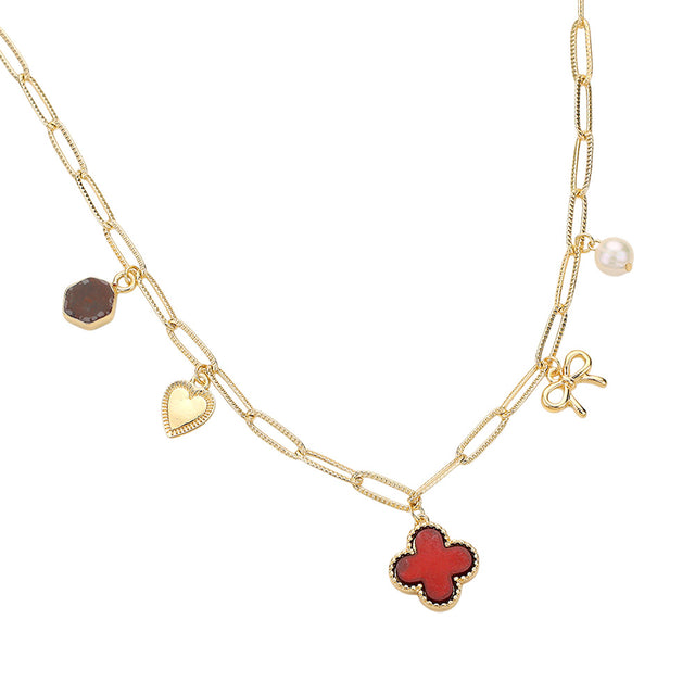 Burgundy Gold Quatrefoil Bow Heart Pearl Charm Station Paperclip Chain Necklace is expertly crafted with a unique design, combining a delicate paperclip chain with charming quatrefoil, bow, and pearl details. Made with high-quality materials, this necklace is elegant and versatile, perfect for any occasion.