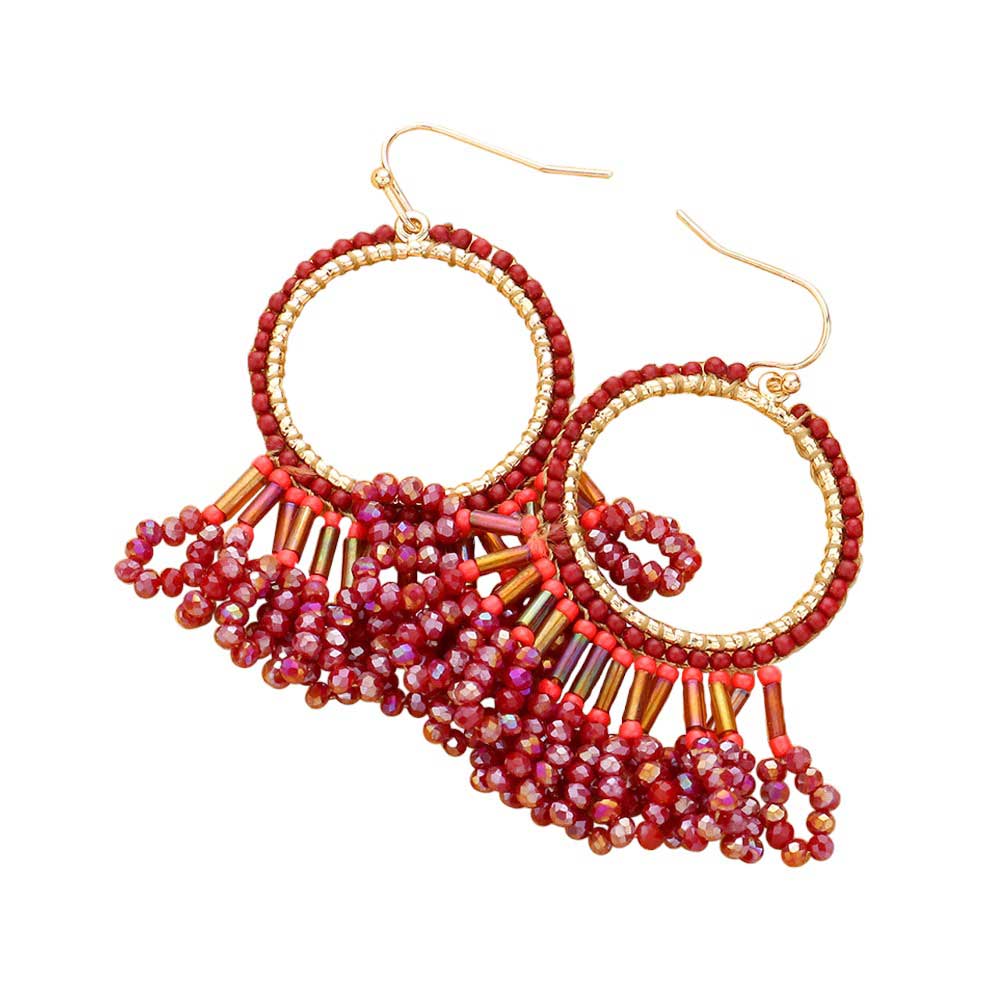 Burgundy Seed Beaded Fringe Metallic Tiered Circle Dangle Earrings, Inject some drama into your look with these stunning pieces. Crafted with layers of tiny seed beads and metallic circles, these beautiful earrings provide a unique and eye-catching addition to any outfit. A perfect accessory for any occasion.