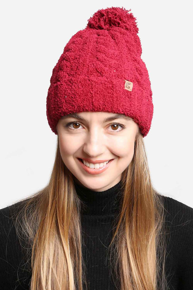 Burgundy Solid Color Pom Beanie features a clean, classic knit design topped with a fluffy pom for a cozy, timeless winter look. Finished with a soft stretch fit, it delivers warm comfort while adding effortless charm to your cold-weather outfits.