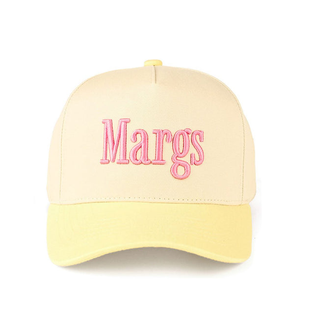 Butter Yellow CC Beanie “MARGS” Lettering Two-Tone Trucker Baseball Snapback Cap features bold embroidered lettering with a stylish two-tone design for a fun, casual look. The classic trucker silhouette with a snapback closure offers breathable comfort and an adjustable fit for everyday wear.