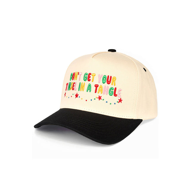 Black The C.C “Don’t Get Your Tinsel in a Tangle” Trucker Cap features a playful holiday slogan with a classic trucker silhouette for a fun, festive look. Designed with a breathable mesh back and adjustable snap closure, it offers lightweight comfort and an easy, customizable fit for everyday wear.