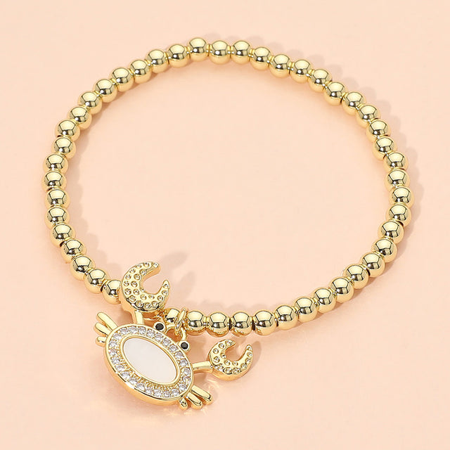 Madeline Love Gold, Mother of Pearl Stainless Steel Mother of Pearl CZ Stone Paved Crab Charm Beaded Stretch Bracelet - Jewelry