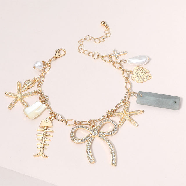 Clear, Gold Stone Paved Bow Metal Starfish Fish Shell Pearl Tropical Leaf Charm Station Bracelet