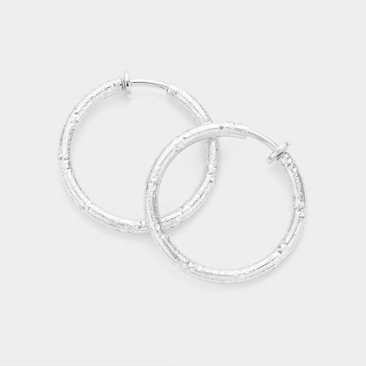 Silver 1.25 Inch Textured Metal Hoop Clip On Earrings