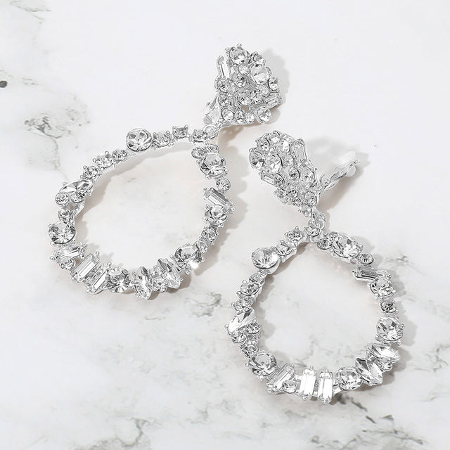 Madeline Love Clear, Silver Bold Mixed Shaped Stone Cluster Embellished Open Teardrop Dangle Evening Clip On Earrings