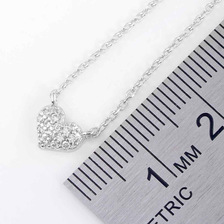 CZ Stone Paved Heart Pendant Necklace exudes elegance and charm. Crafted with precision and adorned with sparkling CZ stones, it brings a touch of glamour to any outfit. Featuring an intricate heart design, it symbolizes love and affection, making it a perfect gift for someone special. 