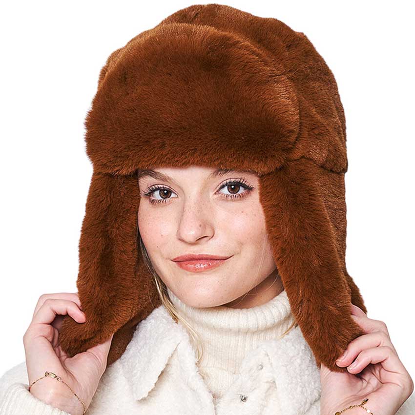 Camel Solid Faux Fur Trapper Hat, is perfect for winter outdoor adventures. Crafted from soft faux fur, the hat will comfortably protect your head from the cold while looking stylish. With its windproof design, this hat is a must-have for winter weather. Ideal gift for your friends and family members on colder days.