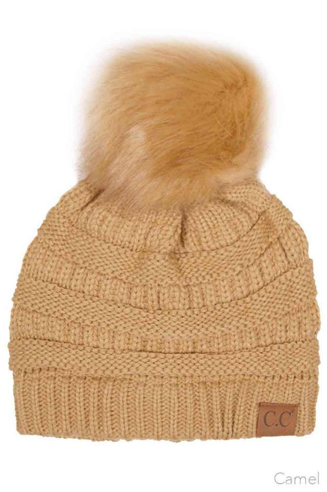 Camel Elevate your winter wardrobe with this classic C.C knitted beanie, crafted from 100% soft acrylic for exceptional warmth and comfort. The signature fur pom pom adds a touch of sophistication, while the one-size-fits-most design ensures a flattering fit for virtually anyone. Perfect for layering during cold months, this versatile beanie transitions seamlessly from casual outings to outdoor adventures. The premium acrylic blend resists pilling and maintains its shape season after season, making it a rel
