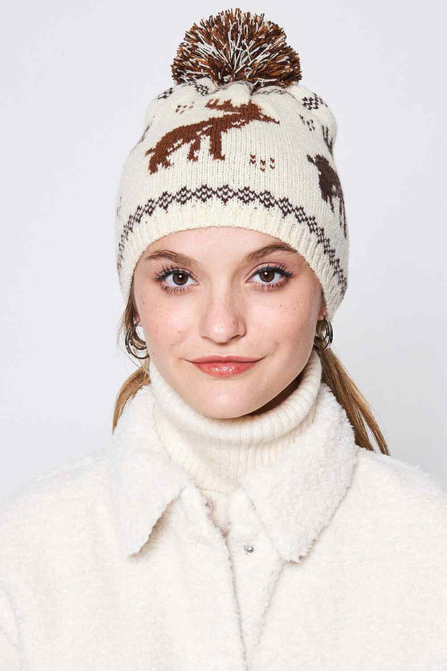 Camel Reindeer Nordic Christmas Holiday Pom Beanie features a festive Nordic knit with adorable reindeer detailing, finished with a fluffy pom for classic winter charm. Designed with a soft stretch fit, it keeps you warm and cozy while adding cheerful holiday style to any cold-weather outfit.