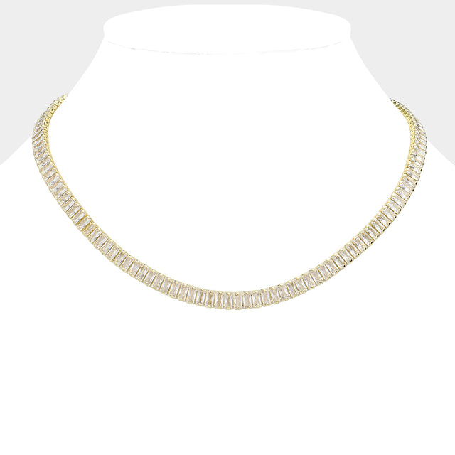 Clear Gold  Stainless Steel Emerald Cut CZ Stone Tennis Chain Necklace exudes elegance and sophistication. Made with durable stainless steel and featuring sparkling emerald cut CZ stones, it's the perfect accessory to elevate any outfit. With its classic tennis chain design and stunning stones, this necklace is a must-have for any jewelry collection.