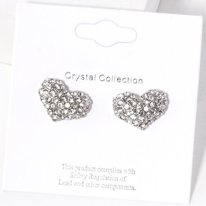 Clear-Rhodium-Crystal Pave Heart Stud Earrings are expertly crafted with sparkling crystals, adding a touch of elegance to any outfit. Made with precision and attention to detail, they are perfect for special occasions or everyday wear. Upgrade your style with these stunning earrings.