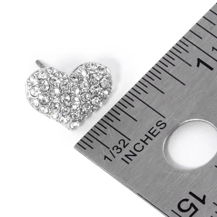 Clear-Rhodium-Crystal Pave Heart Stud Earrings are expertly crafted with sparkling crystals, adding a touch of elegance to any outfit. Made with precision and attention to detail, they are perfect for special occasions or everyday wear. Upgrade your style with these stunning earrings.