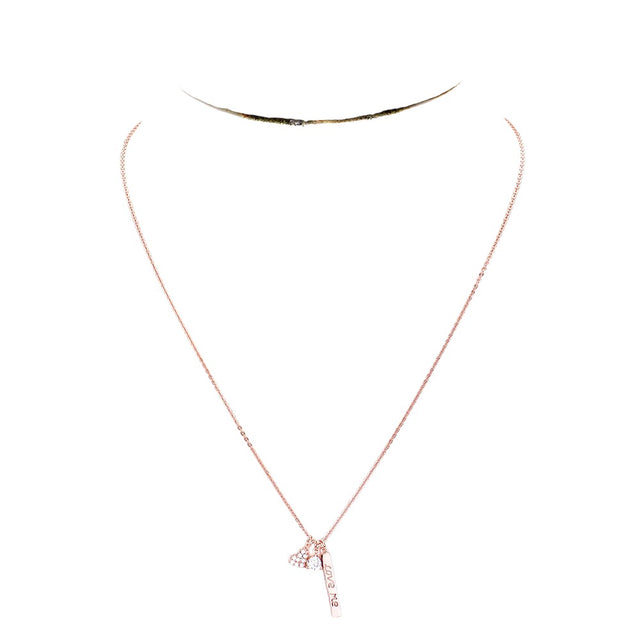 Clear Rose Gold Dipped CZ 'Love Me' Heart Pendant Necklace is the perfect accessory to show your love. The pendant is expertly crafted with cubic zirconia stones and dipped in gold for a stunning and durable shine. A beautiful and meaningful gift for any special occasion.