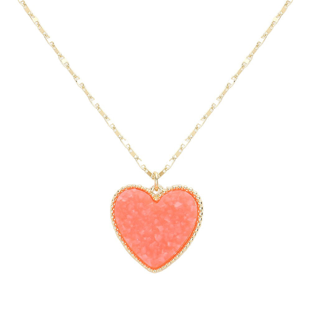 Coral Druzy Heart Pendant Necklace, this is a stunning accessory that adds a touch of sparkle to any outfit. The druzy heart pendant is beautifully crafted and catches the light for a mesmerizing effect. With its unique design and high-quality materials, this necklace is sure to make a statement and elevate your look.