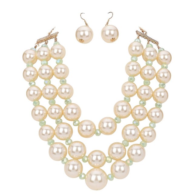 Cream Triple Layered Chunky Pearl Necklace is a gorgeous addition to any outfit. Made with high-quality pearls in a unique triple layer design, this necklace adds a touch of elegance and sophistication to your look. Its chunky style makes a statement while still remaining versatile for any occasion. Upgrade your jewelry collection with this must-have piece. 