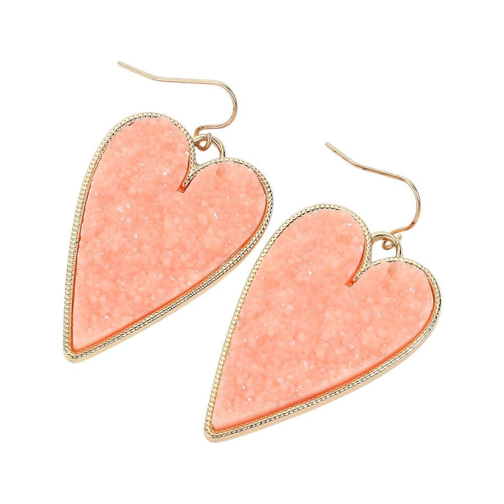 Druzy Heart Dangle Earrings make the perfect addition to any outfit. Featuring gorgeous druzy stones, these earrings bring a touch of elegance and sparkle to your look. The heart-shaped design adds a hint of romance and charm, making them a stunning choice to elevate your style. 