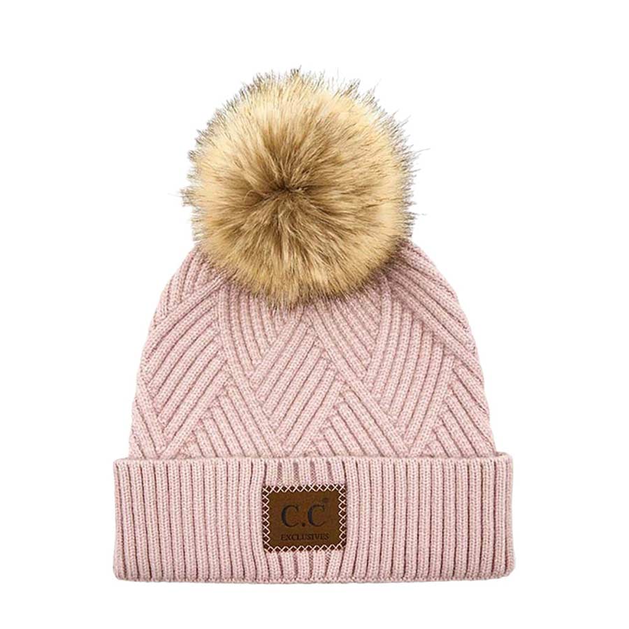 Dusty Rose C.C Heather Beanie Hat With Pom Pom And Suede Patch, provides excellent protection and a fashionable look with its soft heather knit material, faux fur pom pom, and stylish suede patch. The fabric is designed to keep you comfortably warm in cold weather. Add this fashionable accessory to the winter wardrobe collection.