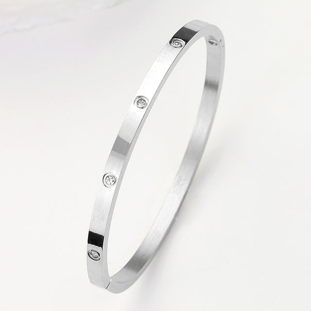 Madeline Love Silver Stainless Steel CZ Stone Embellished Bangle Bracelet - Bracelets