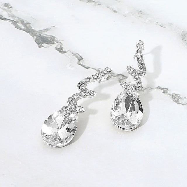 Madeline Love Clear, Silver Teardrop Glass Stone Drop Stone Paved Swirl Evening Earrings