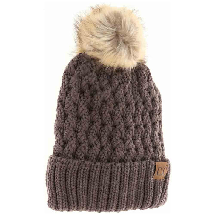 Earth-Grey- Solid Lattice Stitch Fur Pom CC Beanie features a meticulously crafted lattice stitch design that ensures exceptional warmth and durability. Topped with a soft, luxurious fur pom, this beanie combines functional insulation with sophisticated style. Its versatile solid color and expert construction make it an essential accessory for cold-weather protection while elevating your winter wardrobe.