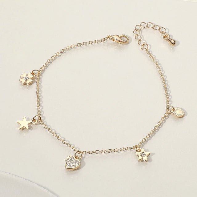 Madeline Love Clear, Gold Stone Paved Heart Star Clover Charm Station Bracelet - Bracelets