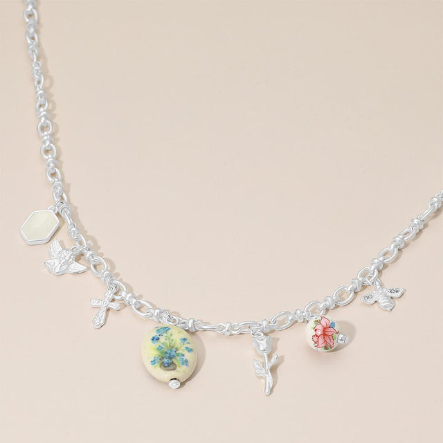 Madeline Love Green, Matte Silver Vintage Floral Ceramic Charm Metal Angel Flower Stem Honey Bee Charm Station Necklace - Necklaces