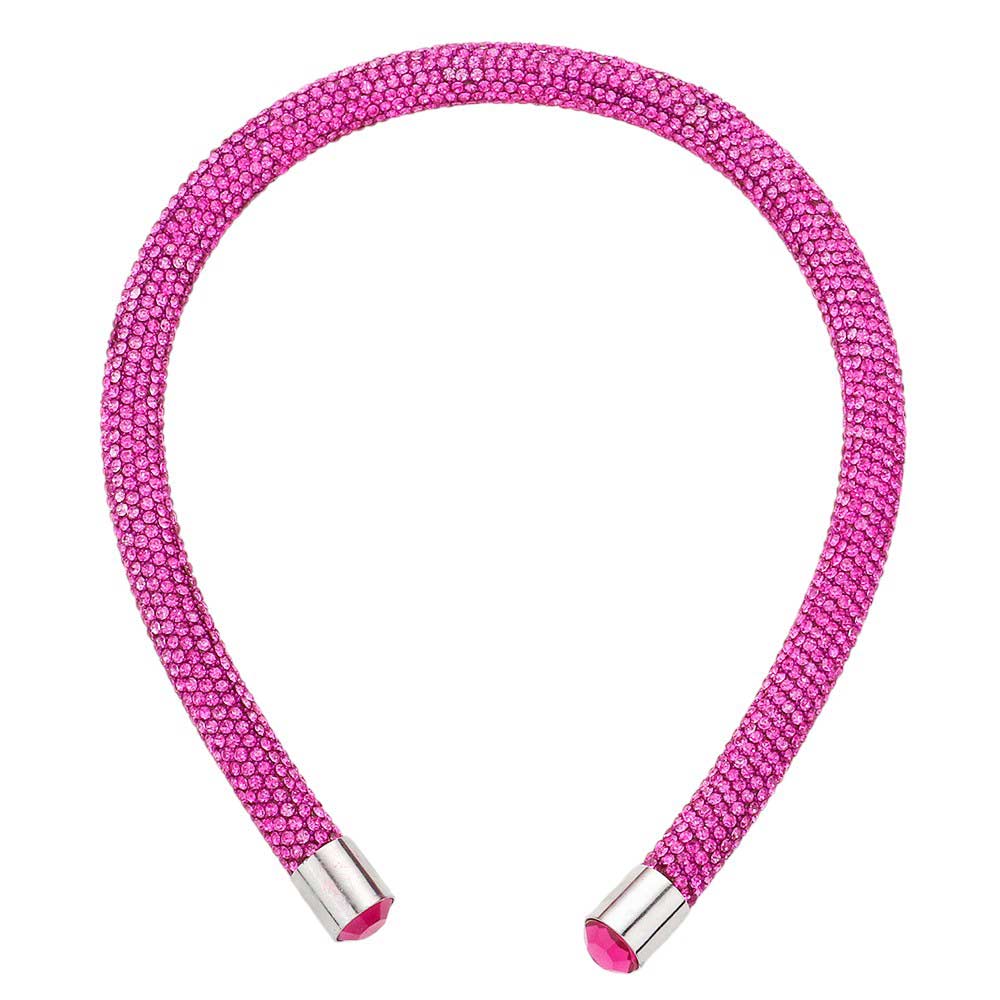 Fuchsia Bling Headband. This stylish accessory is crafted with dazzling jewels and adds a touch of elegance to any outfit. Perfect for special occasions and everyday wear, the Bling Headband is sure to make a statement. Enhance your look with this must-have accessory.