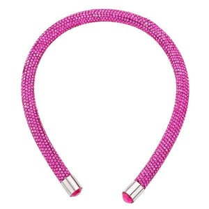 Fuchsia Bling Headband. This stylish accessory is crafted with dazzling jewels and adds a touch of elegance to any outfit. Perfect for special occasions and everyday wear, the Bling Headband is sure to make a statement. Enhance your look with this must-have accessory.
