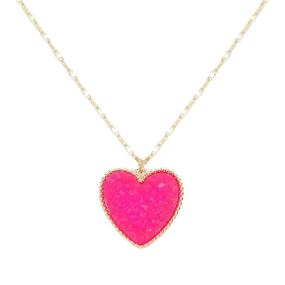 Fuchsia Druzy Heart Pendant Necklace, this is a stunning accessory that adds a touch of sparkle to any outfit. The druzy heart pendant is beautifully crafted and catches the light for a mesmerizing effect. With its unique design and high-quality materials, this necklace is sure to make a statement and elevate your look.