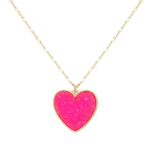 Fuchsia Druzy Heart Pendant Necklace, this is a stunning accessory that adds a touch of sparkle to any outfit. The druzy heart pendant is beautifully crafted and catches the light for a mesmerizing effect. With its unique design and high-quality materials, this necklace is sure to make a statement and elevate your look.