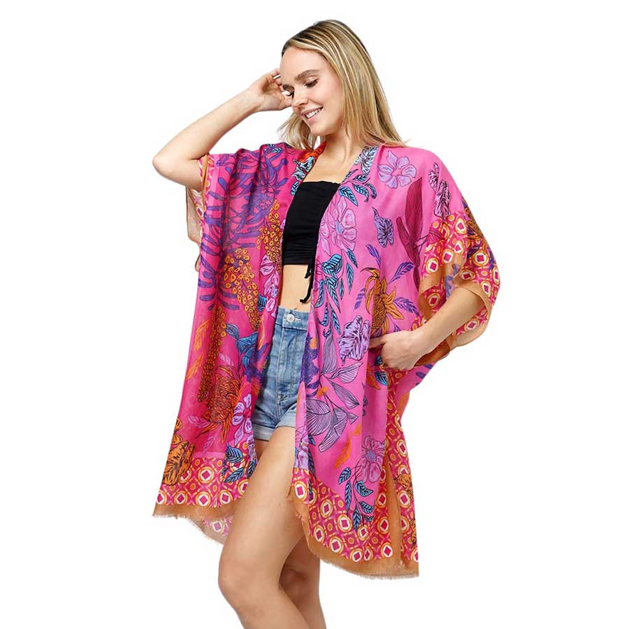 Fuchsia Floral Print Kimono Poncho. Introducing our contemporary poncho, made from high-quality materials, this poncho features a stunning floral print that adds a touch of elegance to any outfit. With its versatile design, it can be worn as a kimono or a poncho, perfect for any occasion. Stay trendy and comfortable.