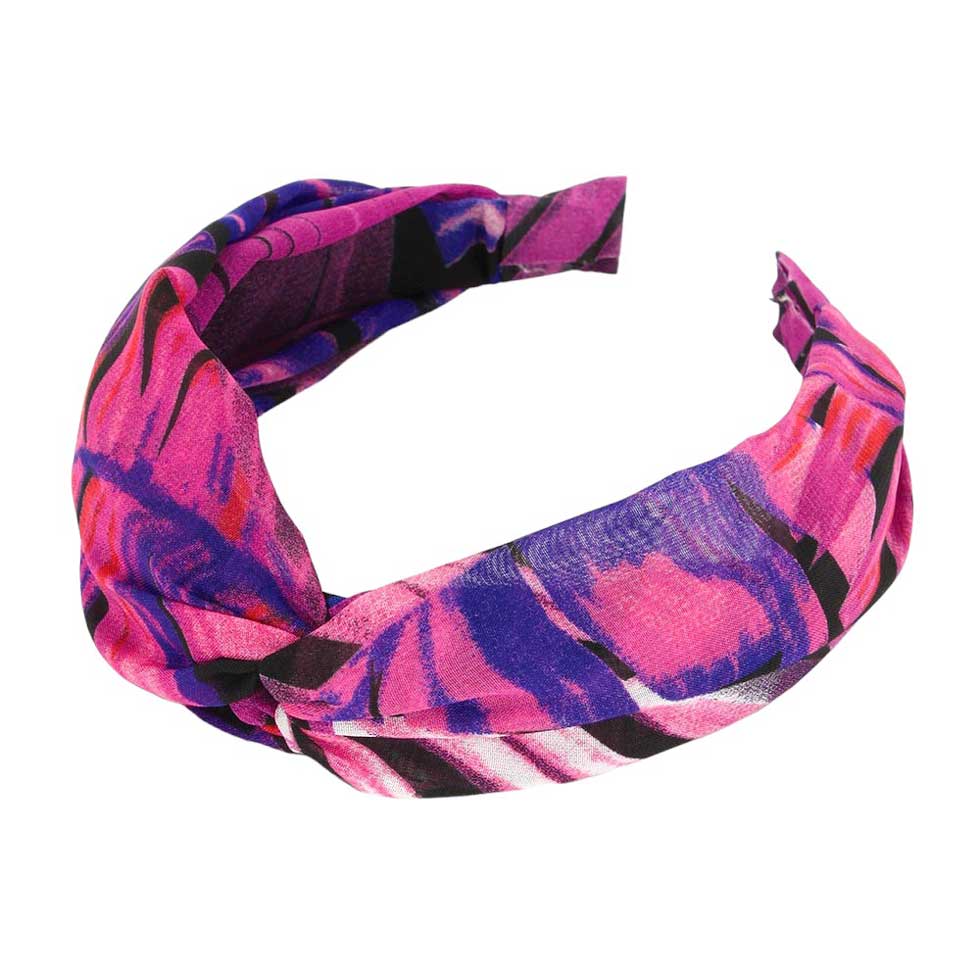 Fuchsia Tropical Leaf Patterned Twisted Headband, perfect for adding a touch of summer to any outfit. Crafted with a unique twisted design and featuring a vibrant tropical leaf pattern, this headband is both stylish and functional. Stay on-trend and keep your hair in place with this fashionable accessory.