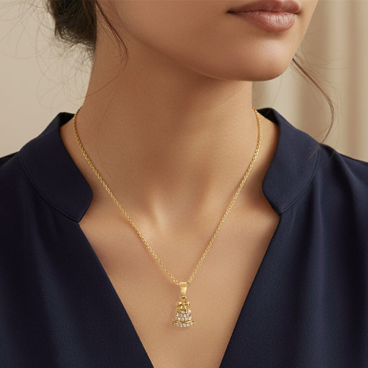 Celebrate the season with this festive bell pendant necklace, beautifully detailed with shimmering accents and a charming bow design. Perfect for holiday wear or as a thoughtful gift, this elegant piece adds timeless sparkle and cheerful style to any jewelry collection.