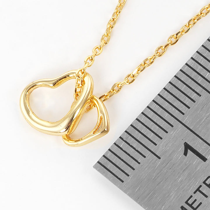 Gold-Dipped Double Heart Pendant Necklace is a chic and timeless accessory that elevates any wardrobe. Crafted from high-quality materials, this necklace features a delicate yet durable design, making it ideal for both everyday wear and special occasions. The gold-dipped double-heart pendant symbolizes love and adds an elegant touch to any outfit.