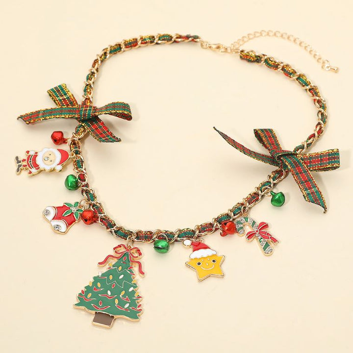 Celebrate the season with this charming holiday necklace featuring playful Christmas-themed pendants and ribbon accents. Perfect for adding a joyful, festive touch to your look, this delightful accessory captures the spirit of the holidays with sparkle and cheer.