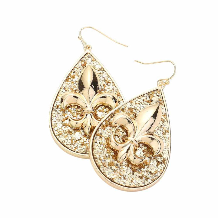 Gold-Fleur de Lis Sparkle Teardrop Dangle Earrings are a striking addition to any outfit. With their intricate design and shimmering sparkle, these earrings are sure to catch the eye. Made with high-quality materials, they offer both style and durability for everyday wear. Elevate your look with these elegant and eye-catching earrings.