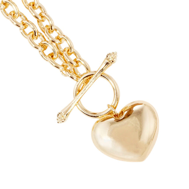Gold Gold Dipped Brass Metal Heart Pendant Toggle Necklace adds a touch of elegance to any outfit. Made from high-quality brass, the necklace features a stunning heart-shaped pendant and a convenient toggle clasp. With its sleek design and luxurious finish, this necklace is the perfect accessory for any occasion.