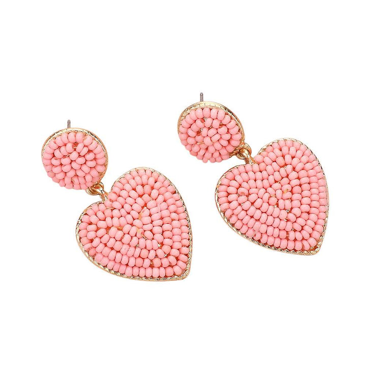 Gold-Light-Pink-Seed Beaded Heart Dangle Earrings are handcrafted with intricate seed beads, adding a delicate and stylish touch to any outfit. The heart-shaped design adds a touch of romance, making them a perfect gift for your loved one. Expertly crafted with quality materials, these earrings are durable and long-lasting. 