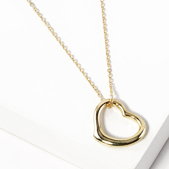 Gold Metal Heart Cut-Out Pendant Necklace showcases a modern cut-out design, adding a touch of elegance to any outfit. Made with high-quality materials, this necklace is both durable and stylish. Elevate your look with this versatile accessory that perfectly blends beauty and functionality. 