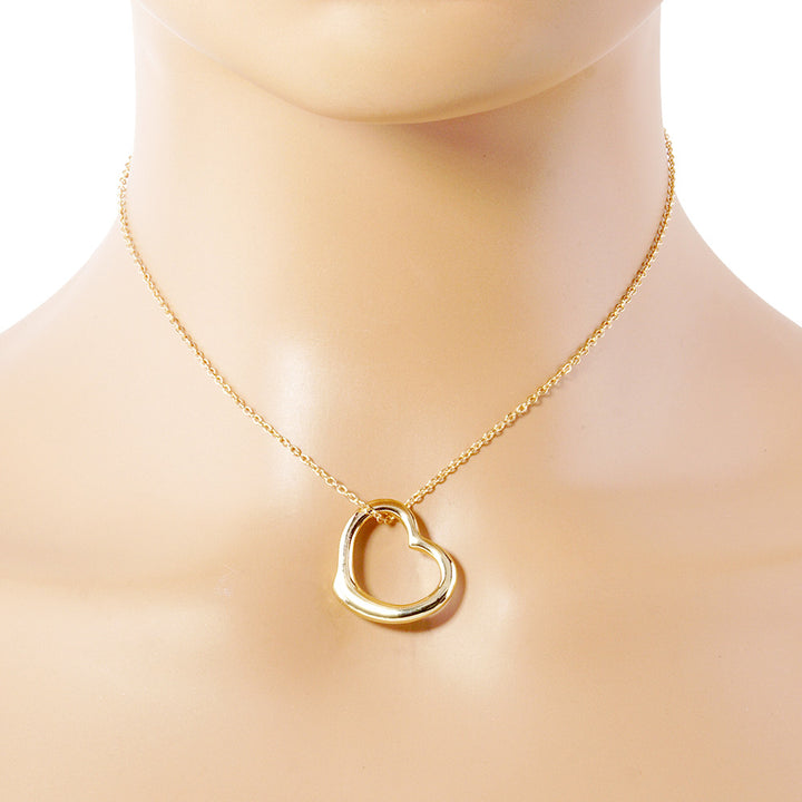 Gold Metal Heart Cut-Out Pendant Necklace showcases a modern cut-out design, adding a touch of elegance to any outfit. Made with high-quality materials, this necklace is both durable and stylish. Elevate your look with this versatile accessory that perfectly blends beauty and functionality. 