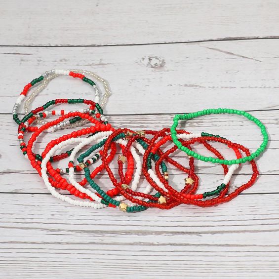 Set of 15 stretch bead bracelets featuring festive holiday tones. Perfect for gifting, stacking, and adding a playful seasonal touch to any display. Lightweight and easy to wear.