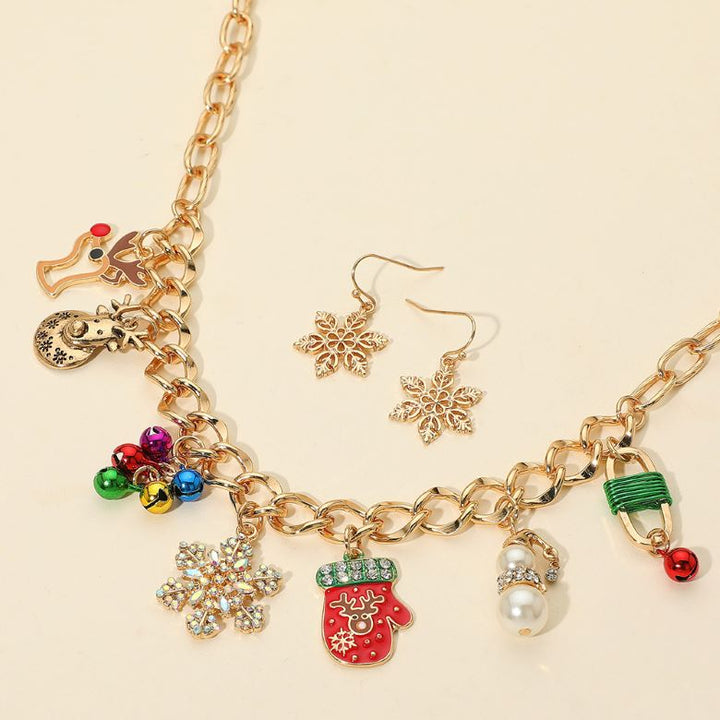 Holiday necklace featuring festive charms like mittens, bells, snowflakes, and reindeer. Comes with matching snowflake earrings. A cheerful accessory for seasonal events or gifting.