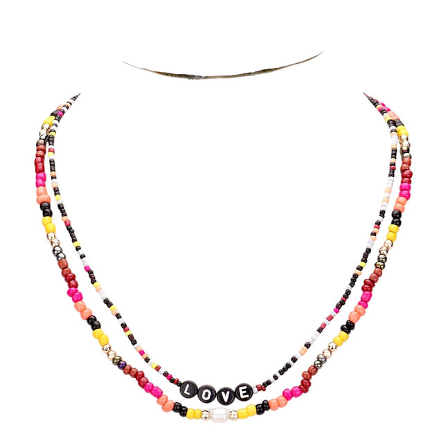 Gold Multi Color Bead Statement Love Layered Necklace adds a pop of color to any outfit! The multi-layered design and vibrant beads create a unique statement piece that is sure to catch attention. Elevate your style with this eye-catching necklace.
