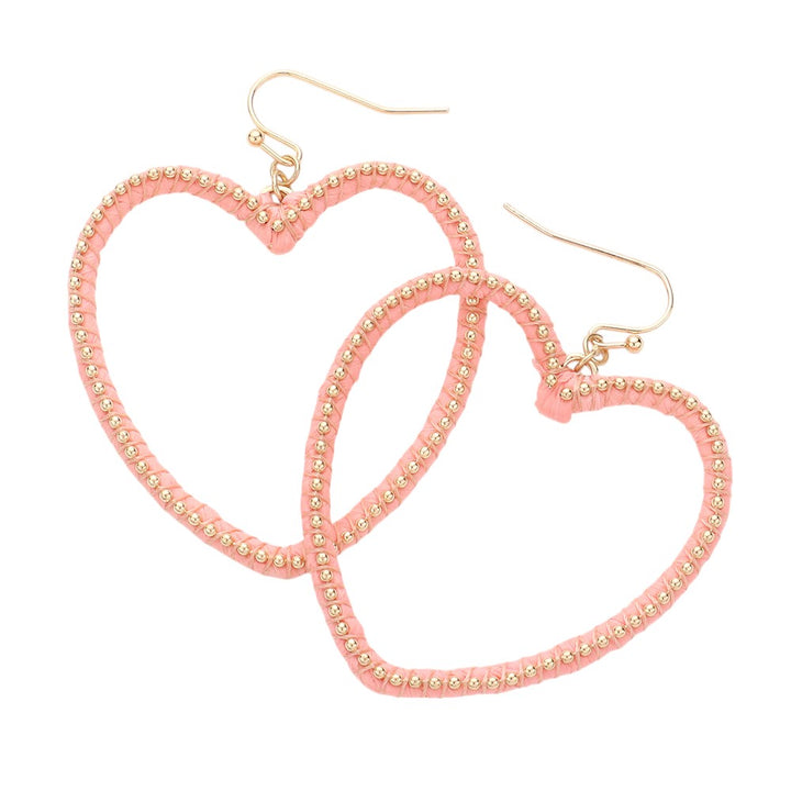 Gold Peach Raffia Metal Ball Wrapped Open Heart Dangle Earrings add a touch of sophistication to any outfit. The delicate raffia wrapping and open heart design make them a unique and stylish accessory. Handcrafted with precision, these earrings are a must-have for any fashion-forward individual.