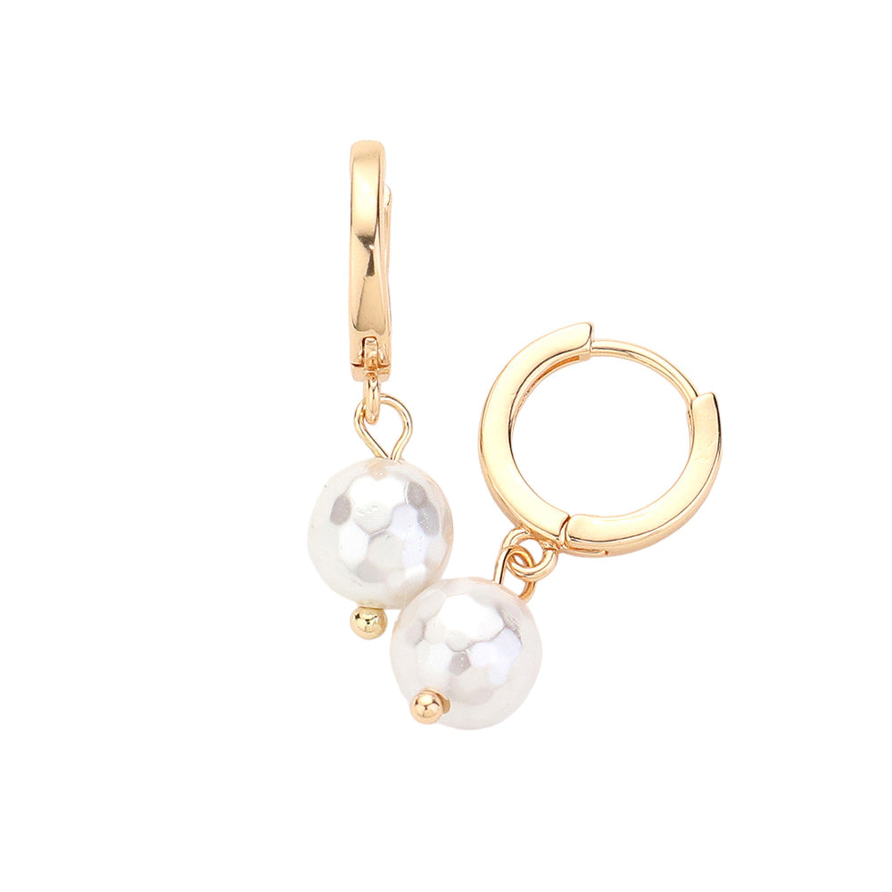 Gold Pearl Dangle Huggie Earrings. These elegant earrings feature a delicate pearl dangle, adding a touch of sophistication to any outfit. Crafted with high-quality materials, these earrings are both lightweight and comfortable. Perfect for any occasion, these earrings will make a stylish statement.