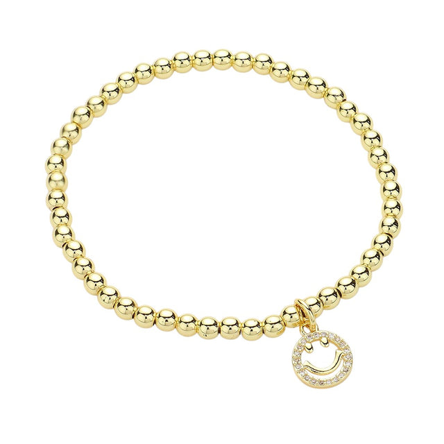 Gold Stainless Steel Stone Paved Smile Emoji Charm Stretch Ball Bracelet is a unique and stylish accessory that adds a touch of fun and playfulness to any outfit. Made with high-quality stainless steel and adorned with a stone paved smile emoji charm, this stretch bracelet is not only durable but also eye-catching. Complete your look with a smile, and get ready to receive compliments.